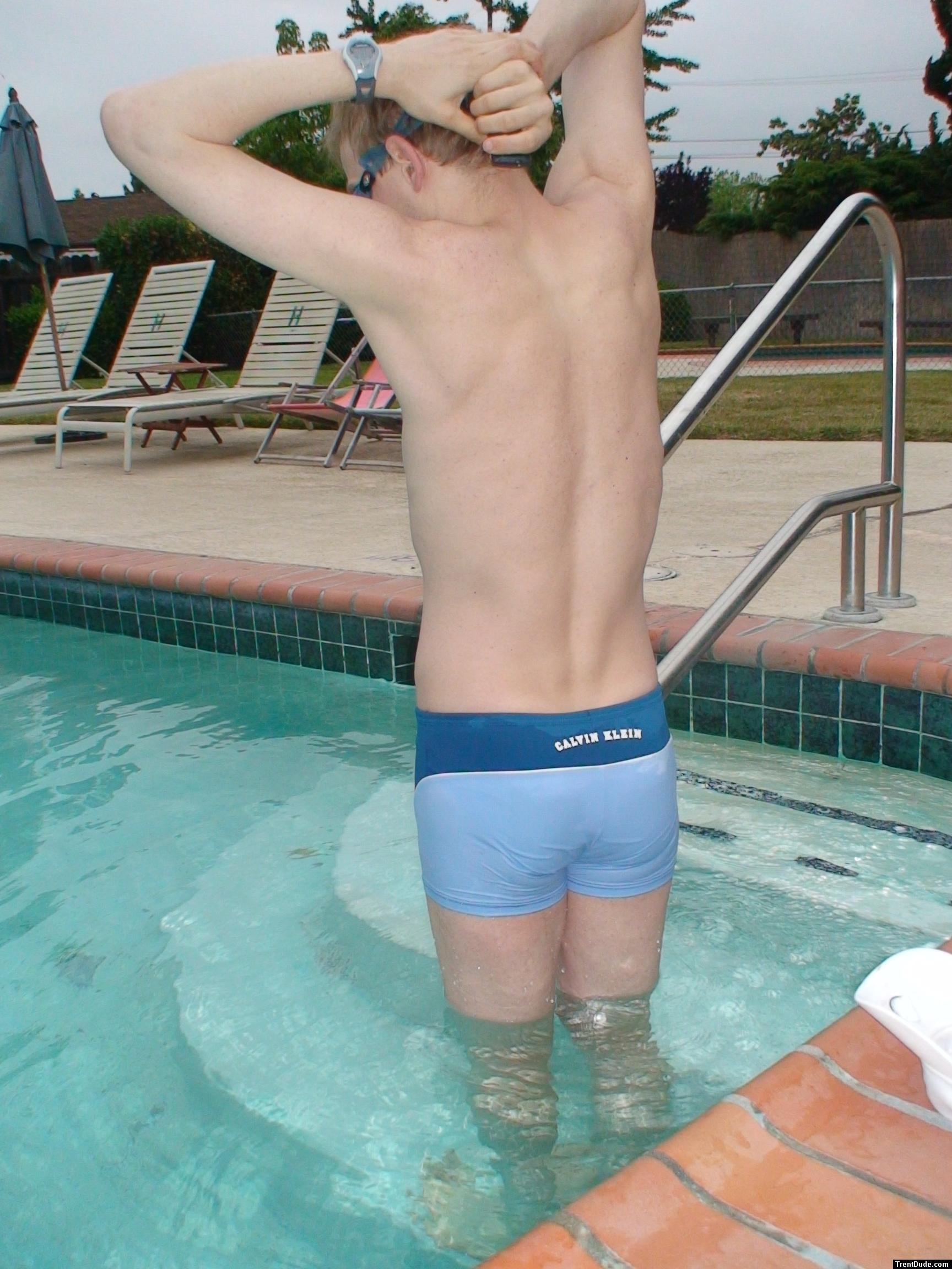 flexing his back muscles - Calvin Klein swim boxer (rear)
