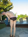 Bending over to dry his feet