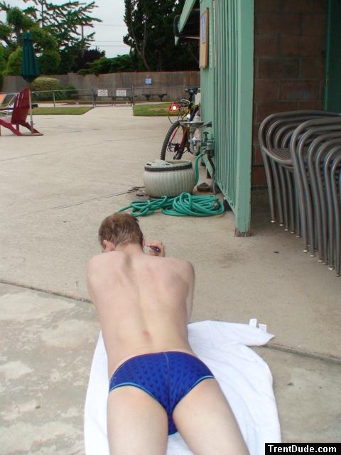 swimmer laying on a towel i(Speedo Fastskin Royal Blue brief from speedousa.com) (rear)