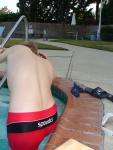 stretching in a Red Speedo Trunk