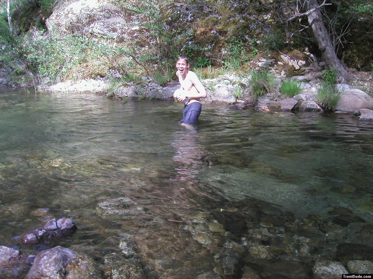 Trent in a creek on a camping trip wearing boxers