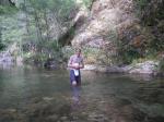 Trent in a creek on a camping trip wearing boxers
