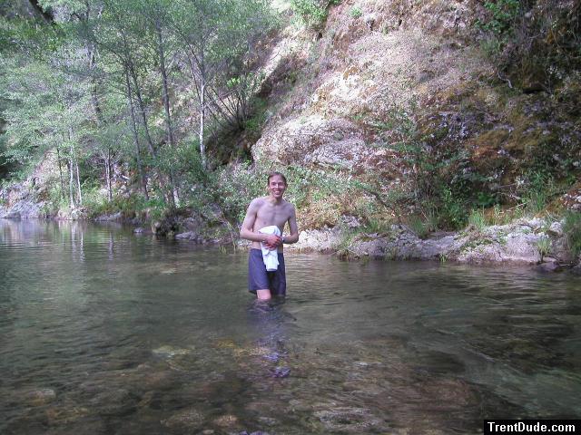 Trent in a creek on a camping trip wearing boxers