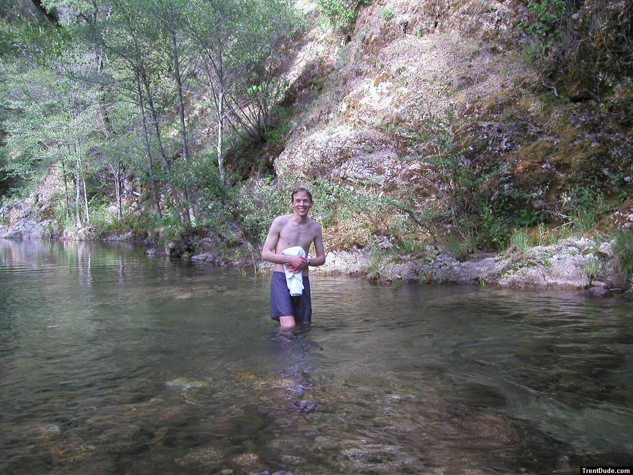 Trent in a creek on a camping trip wearing boxers