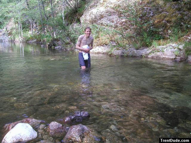 Trent in a creek on a camping trip wearing boxers