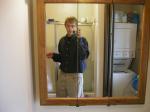 Taking a photo in the mirror wearing tan Wrangler jeans