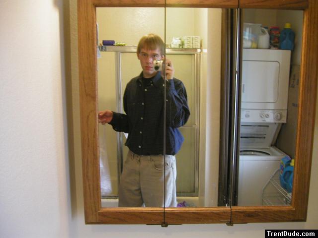 Taking a photo in the mirror wearing tan Wrangler jeans