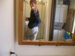 Taking a photo in the mirror wearing tan Wrangler jeans