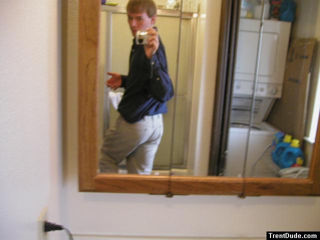 Taking a photo in the mirror wearing tan Wrangler jeans