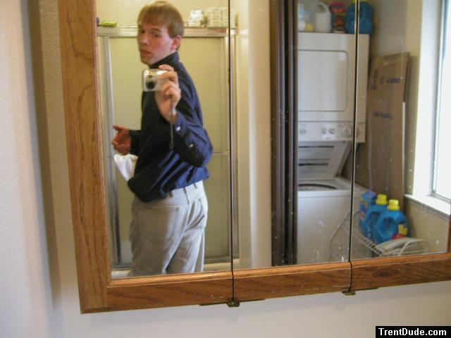 Taking a photo in the mirror wearing tan Wrangler jeans