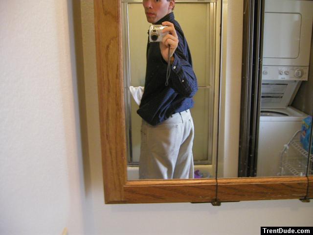 Taking a photo in the mirror wearing tan Wrangler jeans