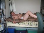 Laying in bed in white briefs