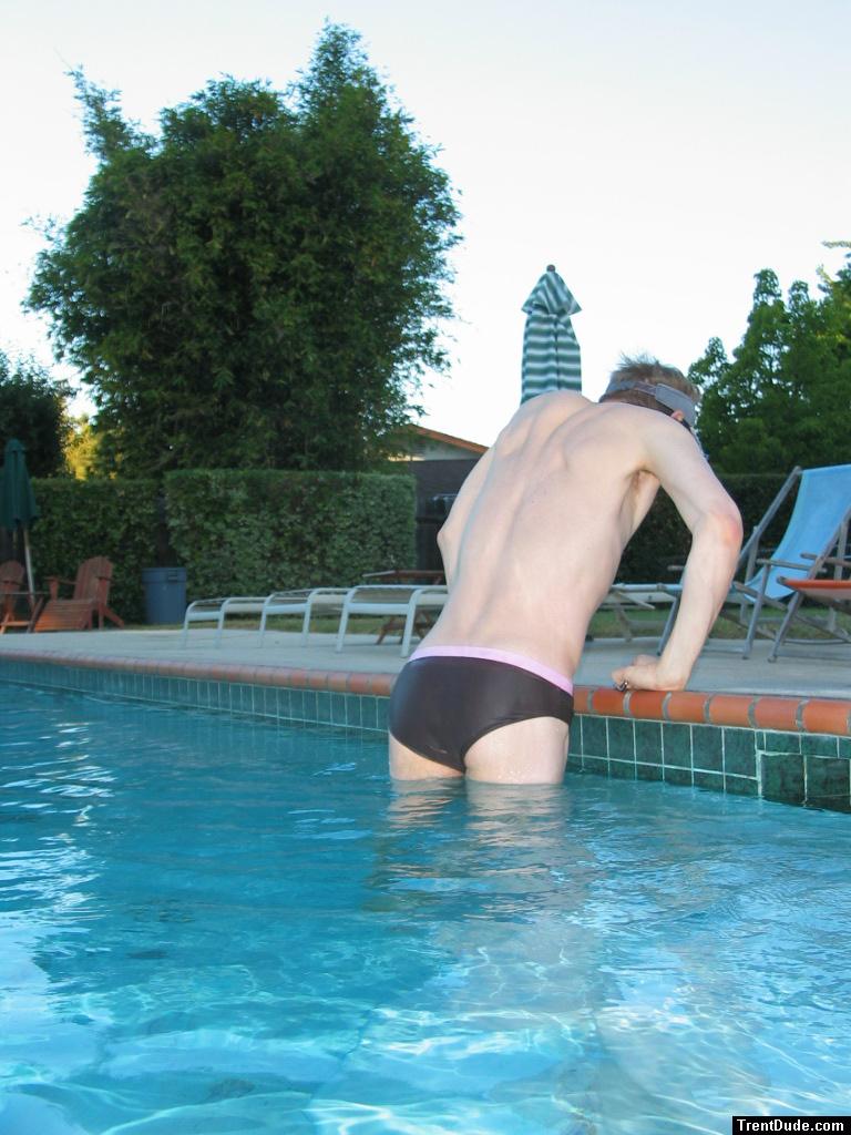 Swimmer getting out of the pool in a speedo brief