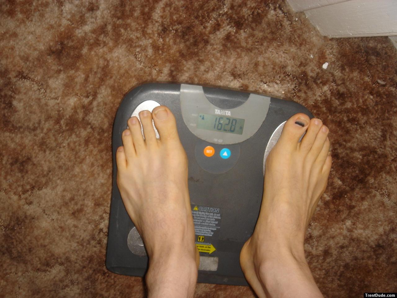 Trent's feet while weighing himself on a scale