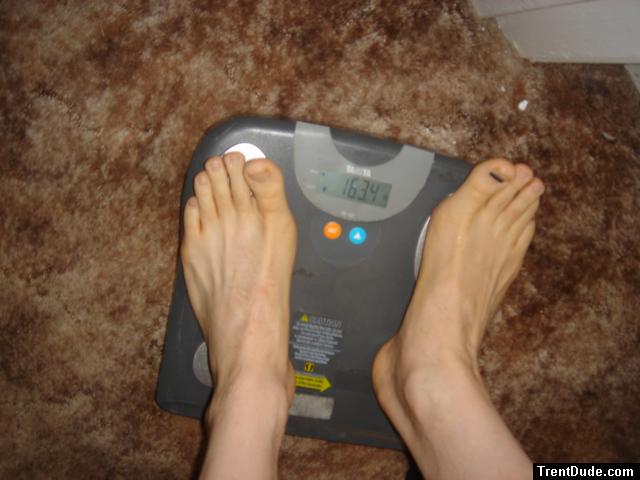 Trent's feet while weighing himself on a scale