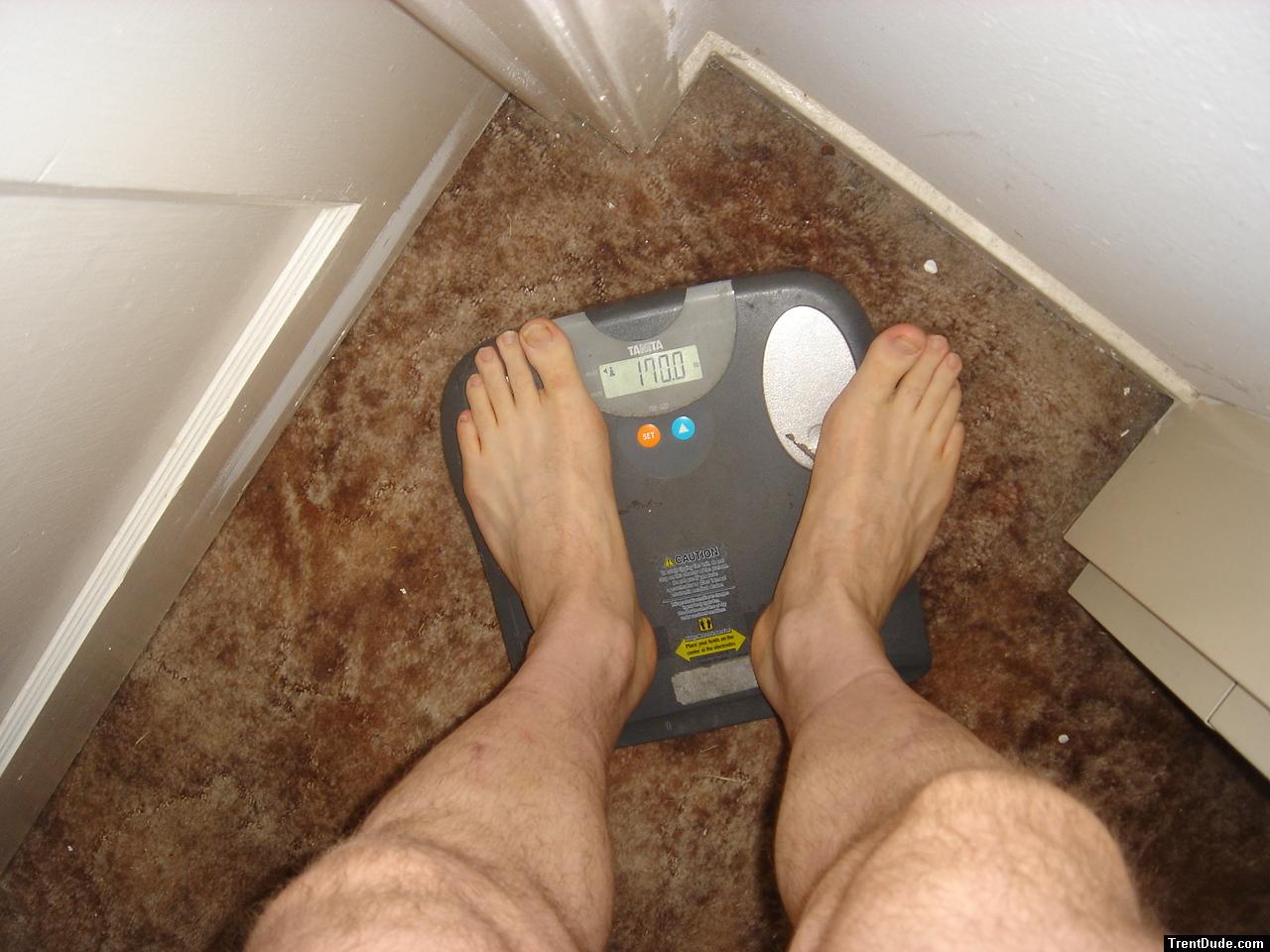 Trent's feet while weighing himself on a scale