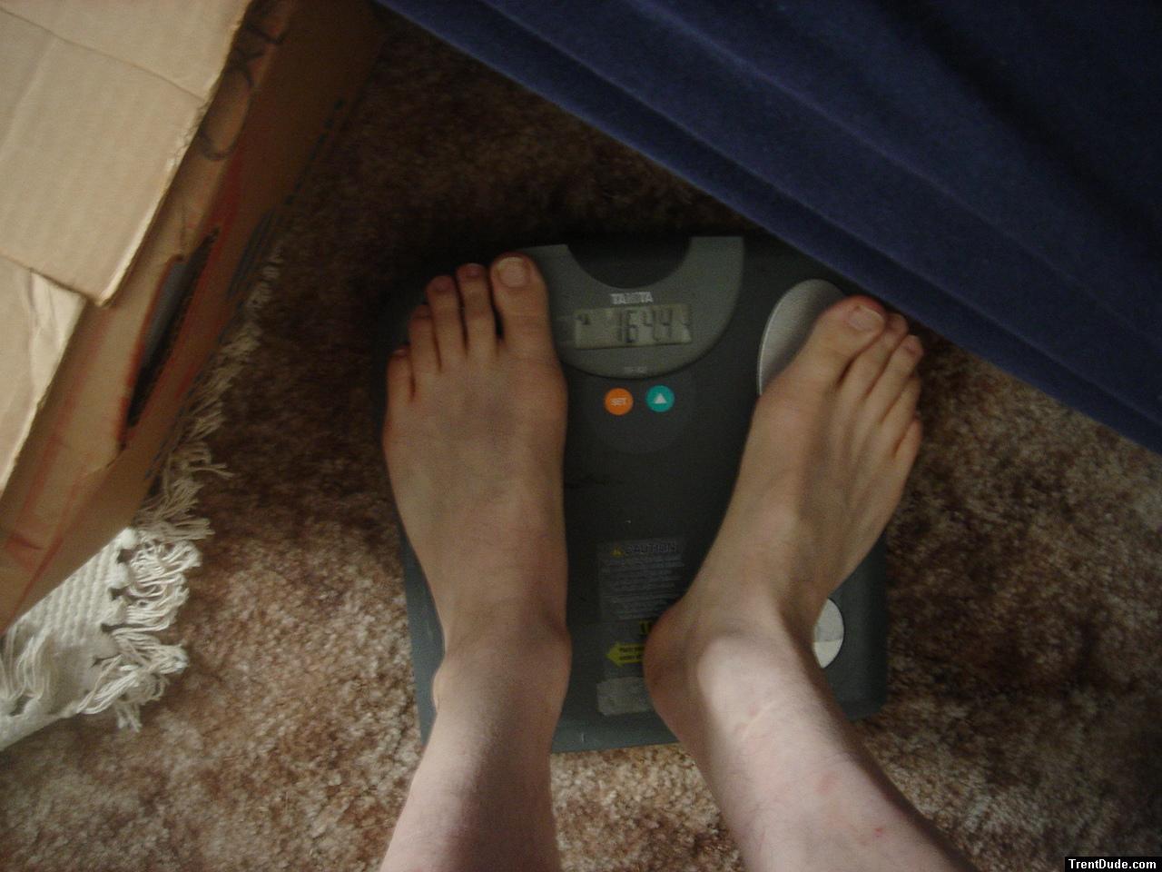 Trent's feet while weighing himself on a scale