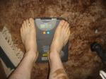 Trent's feet while weighing himself on a scale