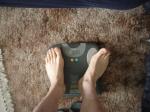 Trent's feet while weighing himself on a scale