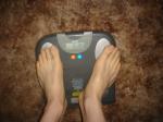 Trent's feet while weighing himself on a scale