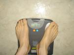 Trent's feet while weighing himself on a scale
