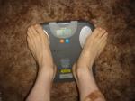 Trent's feet while weighing himself on a scale