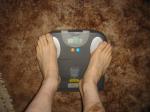 Trent's feet while weighing himself on a scale
