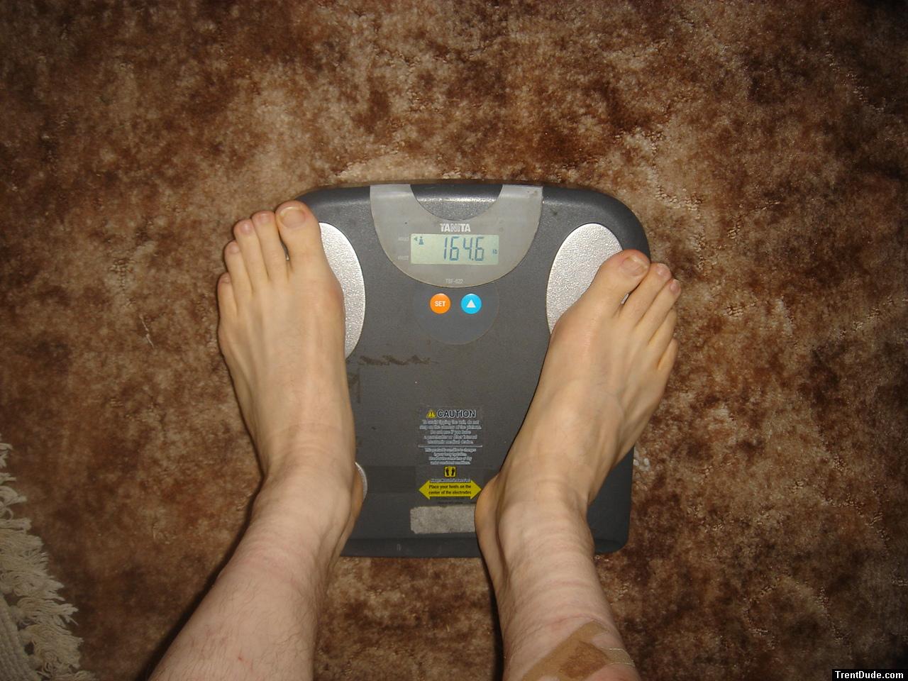 Trent's feet while weighing himself on a scale