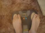 Trent's feet while weighing himself on a scale