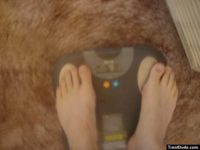 Trent's feet while weighing himself on a scale