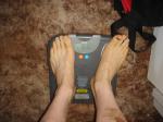 Trent's feet while weighing himself on a scale