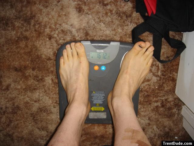 Trent's feet while weighing himself on a scale