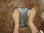Trent's feet while weighing himself on a scale