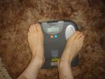 Trent's feet while weighing himself on a scale