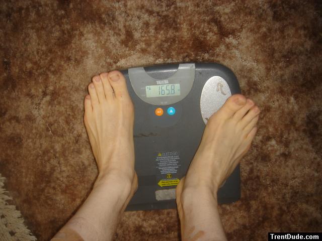 Trent's feet while weighing himself on a scale