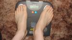 Trent's feet while weighing himself on a scale