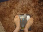 Trent's feet while weighing himself on a scale