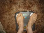 Trent's feet while weighing himself on a scale