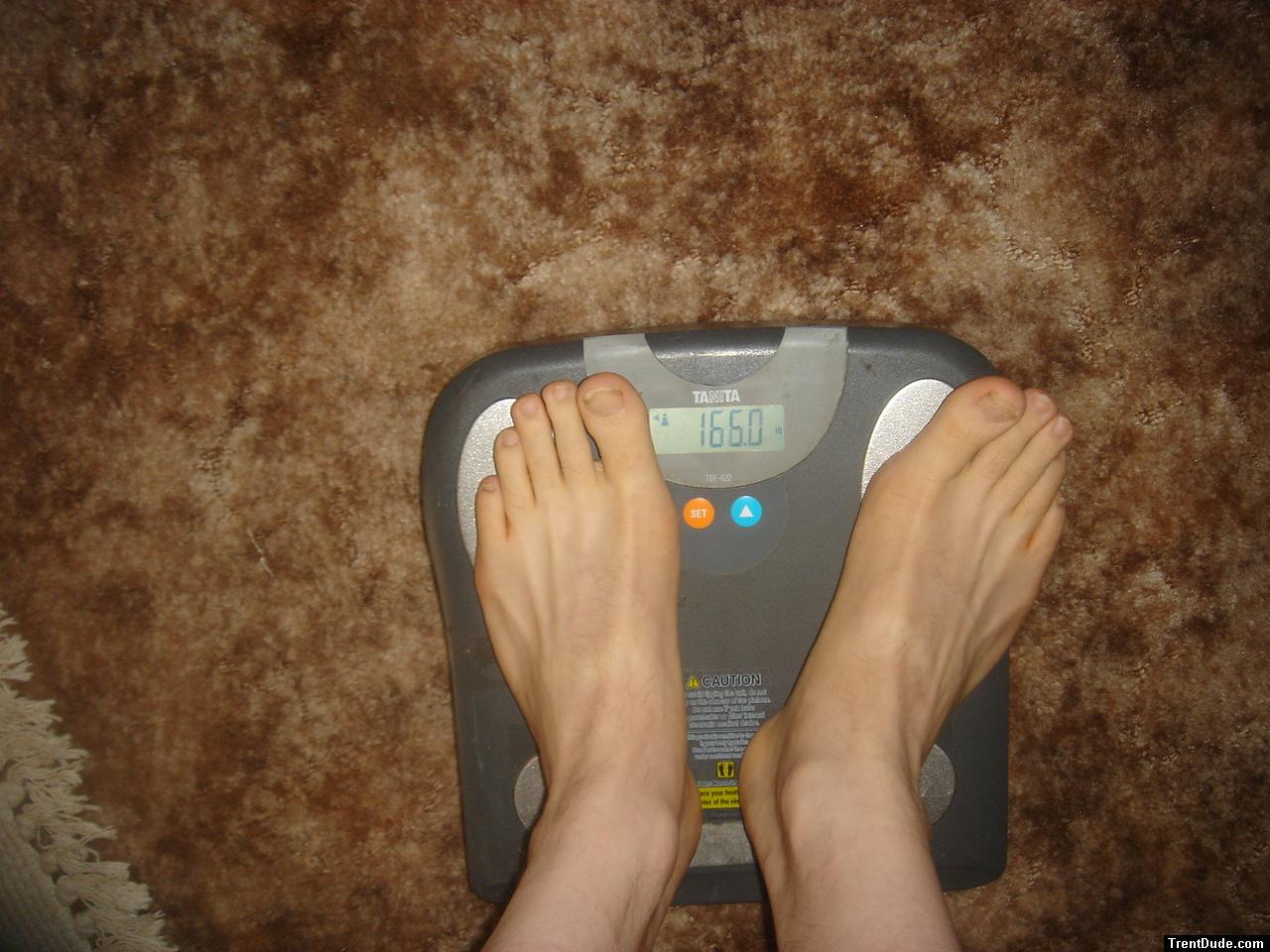 Trent's feet while weighing himself on a scale