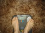 Trent's feet while weighing himself on a scale