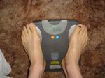 Trent's feet while weighing himself on a scale