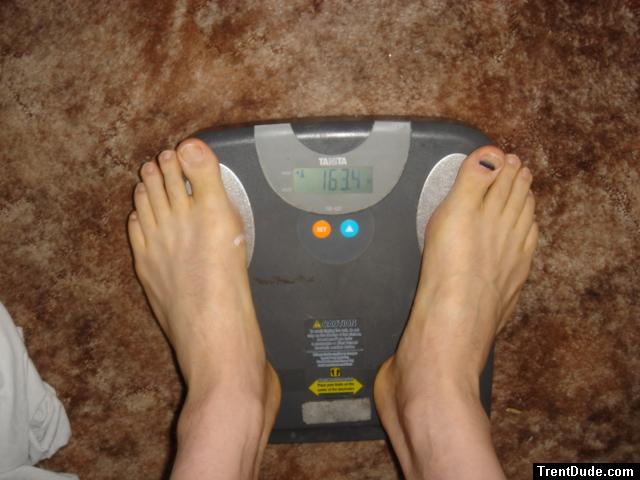Trent's feet while weighing himself on a scale