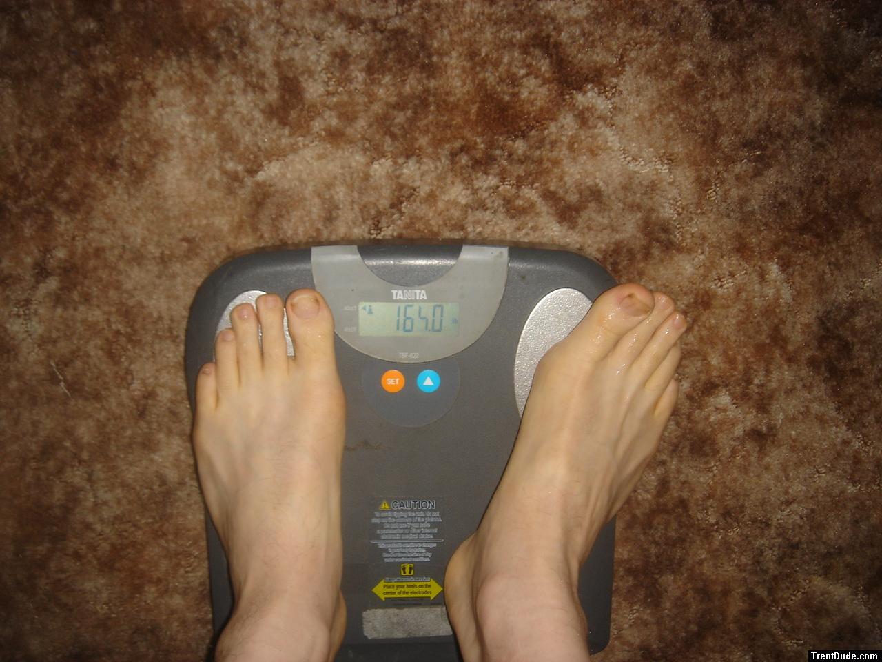 Trent's feet while weighing himself on a scale