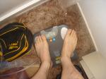 Trent's feet while weighing himself on a scale