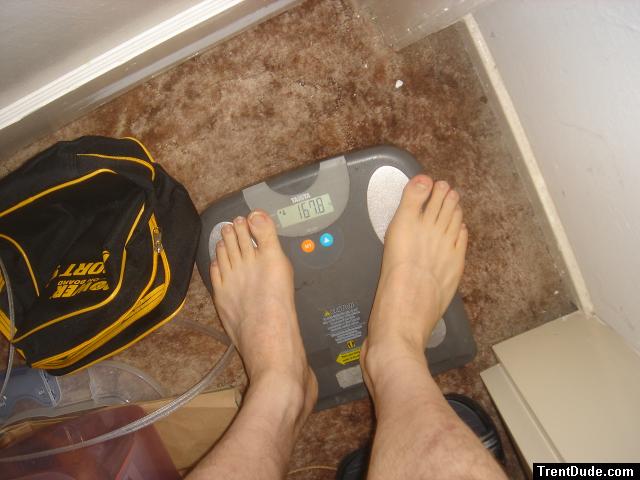 Trent's feet while weighing himself on a scale