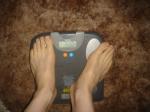 Trent's feet while weighing himself on a scale