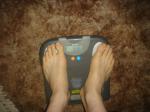 Trent's feet while weighing himself on a scale