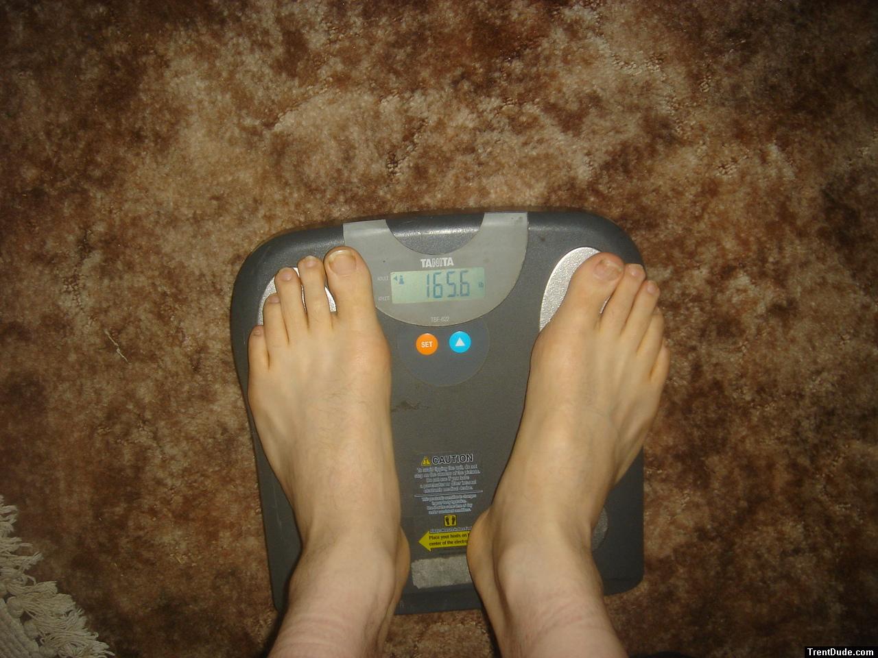 Trent's feet while weighing himself on a scale