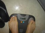 Trent's feet while weighing himself on a scale