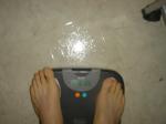 Trent's feet while weighing himself on a scale